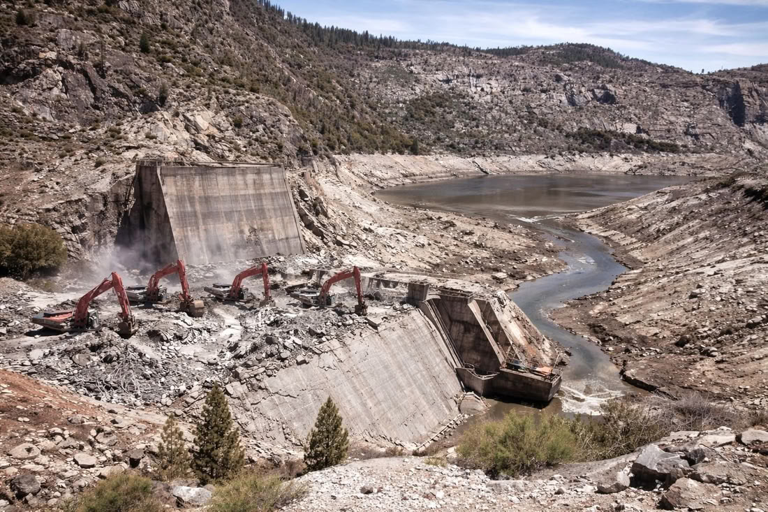 Removing O'Shaughnessy Dam with heavy machines and explosives